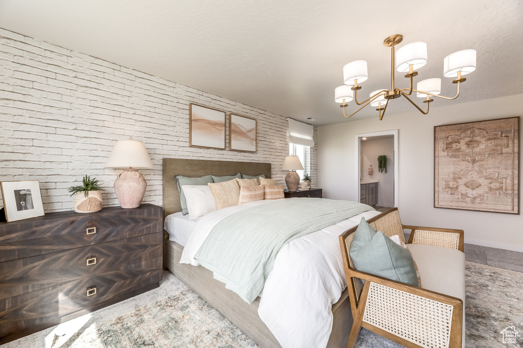 Bedroom featuring a notable chandelier and ensuite bathroom