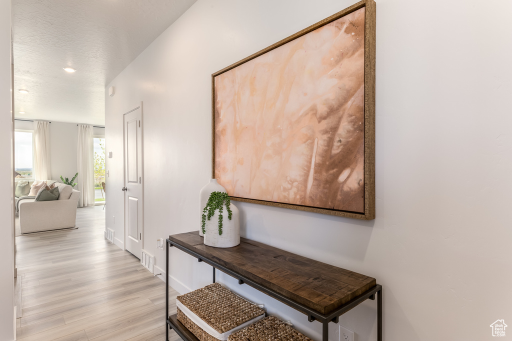 Hall featuring baseboards and light wood-type flooring