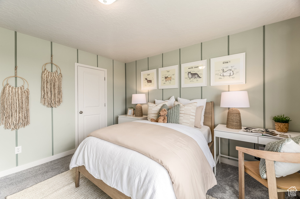 Carpeted bedroom featuring baseboards