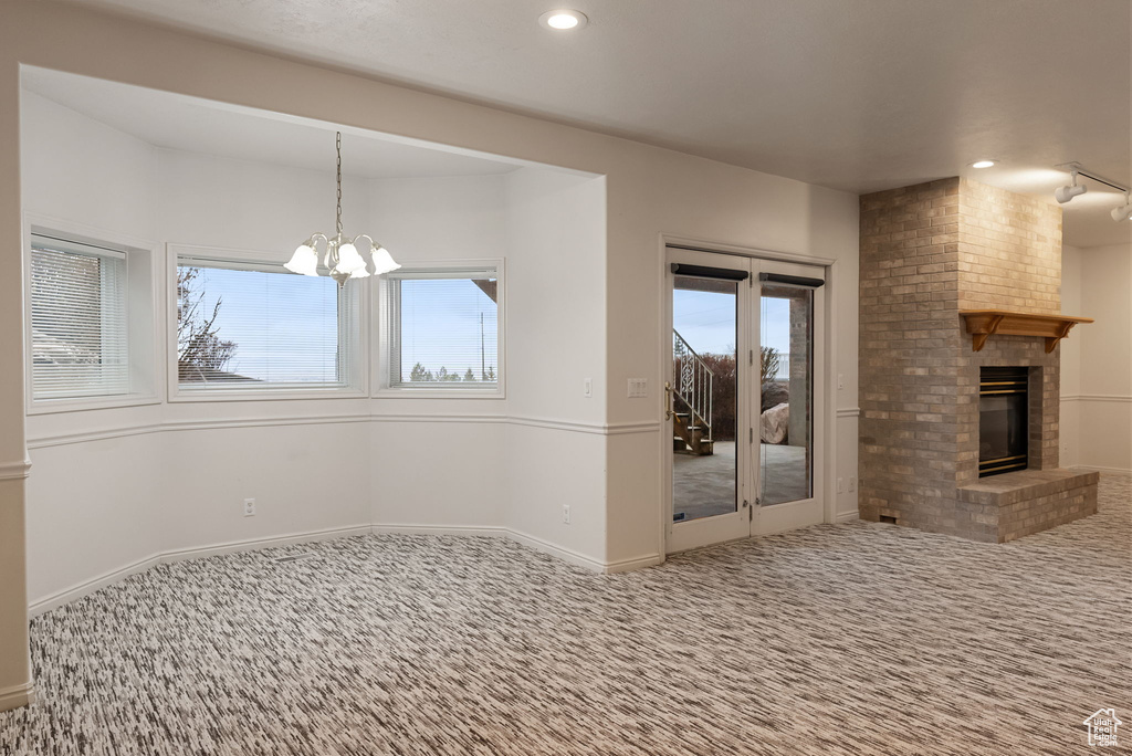 Interior space featuring a fireplace, carpet floors, a wealth of natural light, and recessed lighting