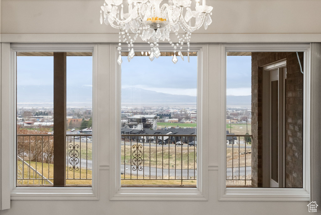 Unfurnished dining area with plenty of natural light, a mountain view, and an inviting chandelier