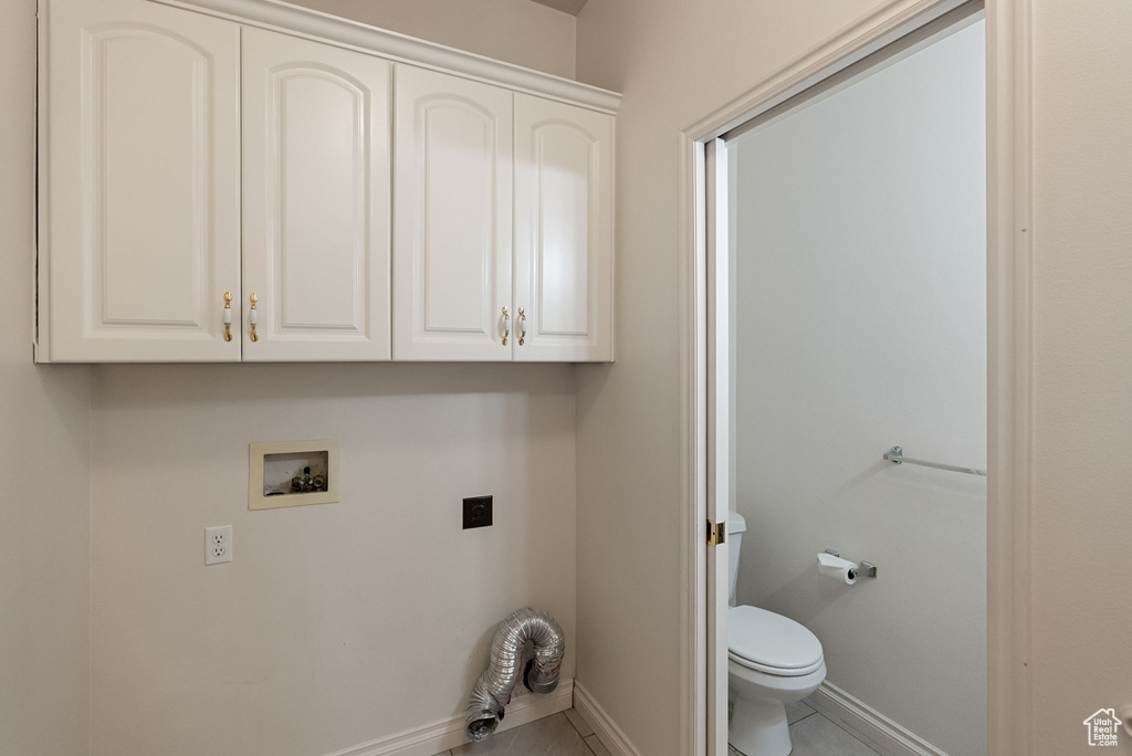 Washroom with tile patterned floors, electric dryer hookup, baseboards, and washer hookup