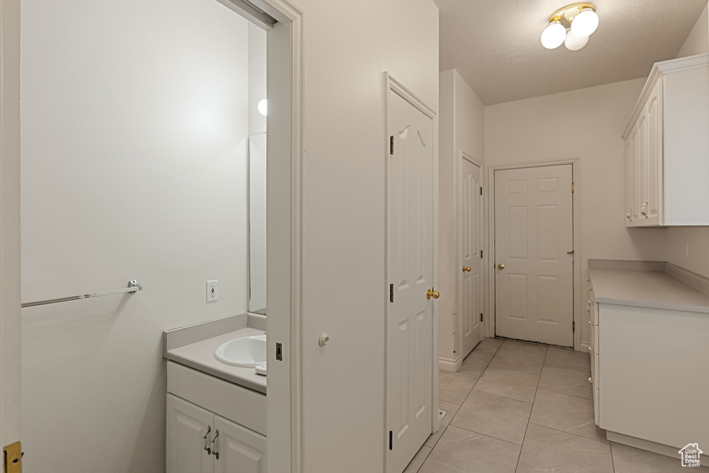 Bathroom with tile patterned flooring and vanity