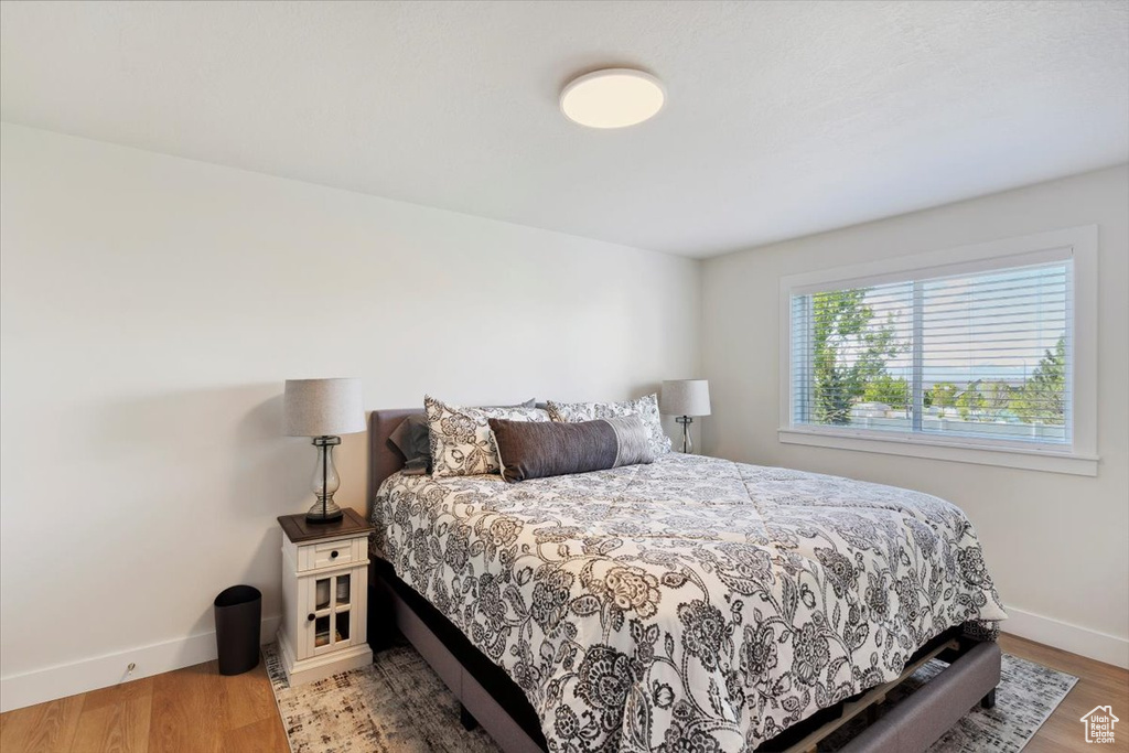 Bedroom featuring baseboards and wood finished floors