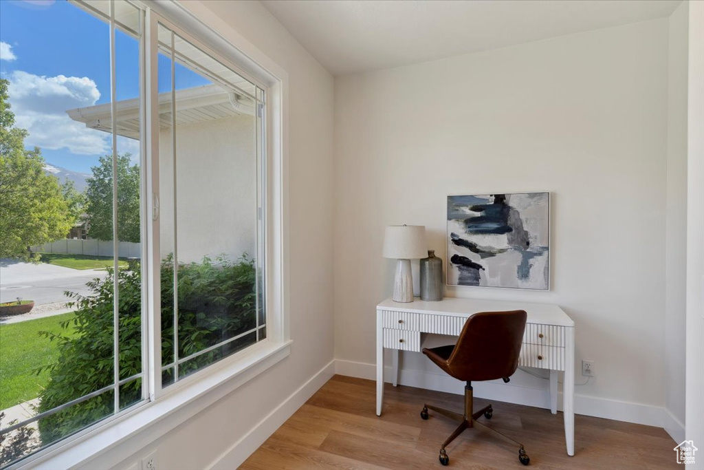 Office area with baseboards and wood finished floors
