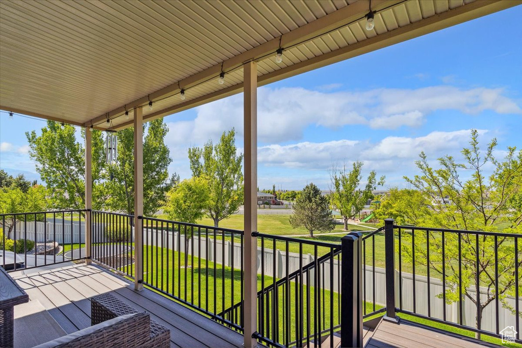 Wooden terrace featuring a yard