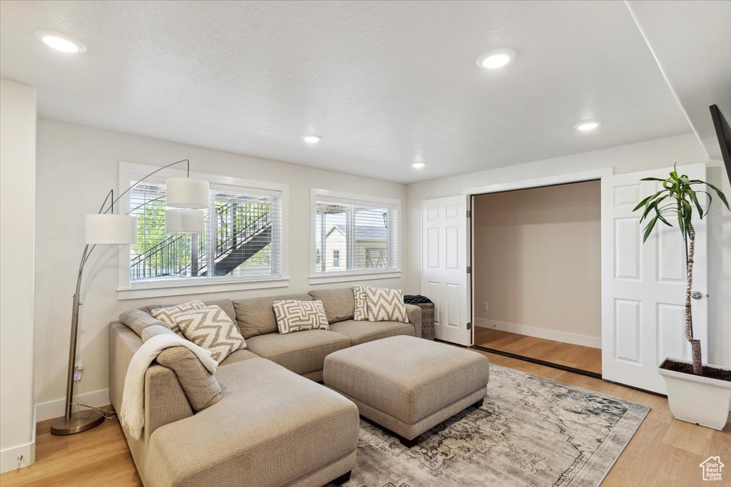 Living area featuring recessed lighting, baseboards, and light wood-style flooring