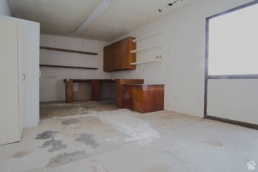 Kitchen with concrete flooring and open shelves