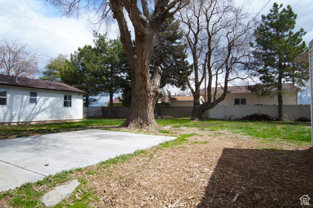 View of yard with a fenced backyard and a patio area