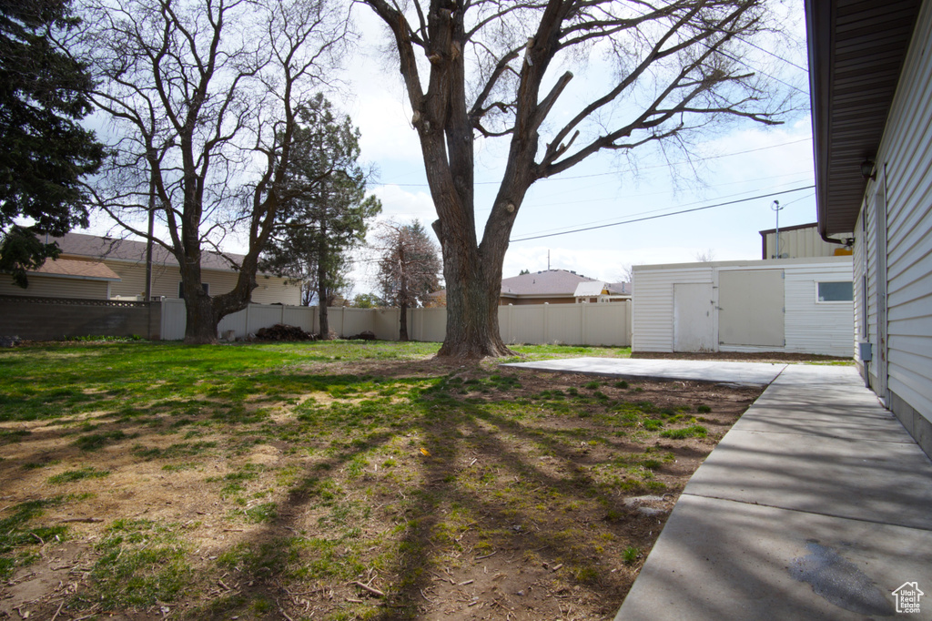 View of yard featuring fence and a patio area