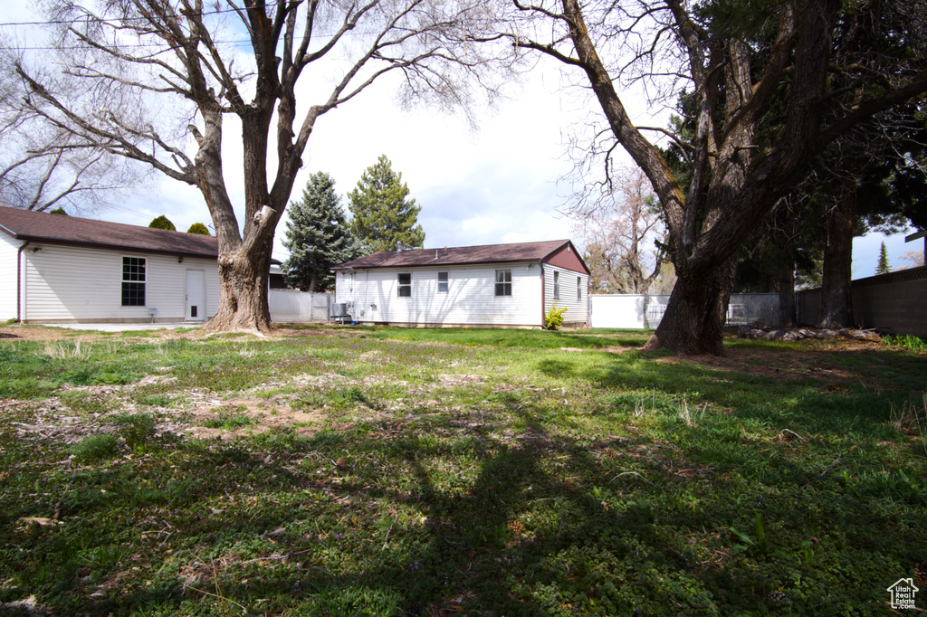 View of yard featuring fence and an outdoor structure