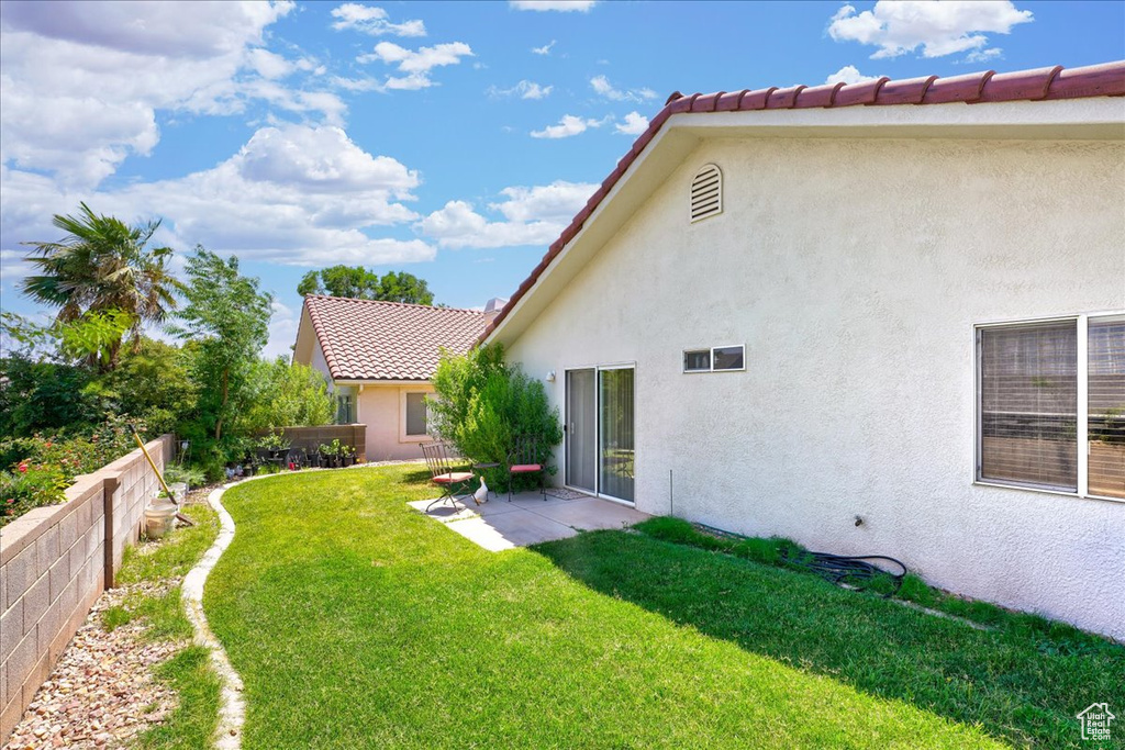 View of yard with a fenced backyard and a patio area