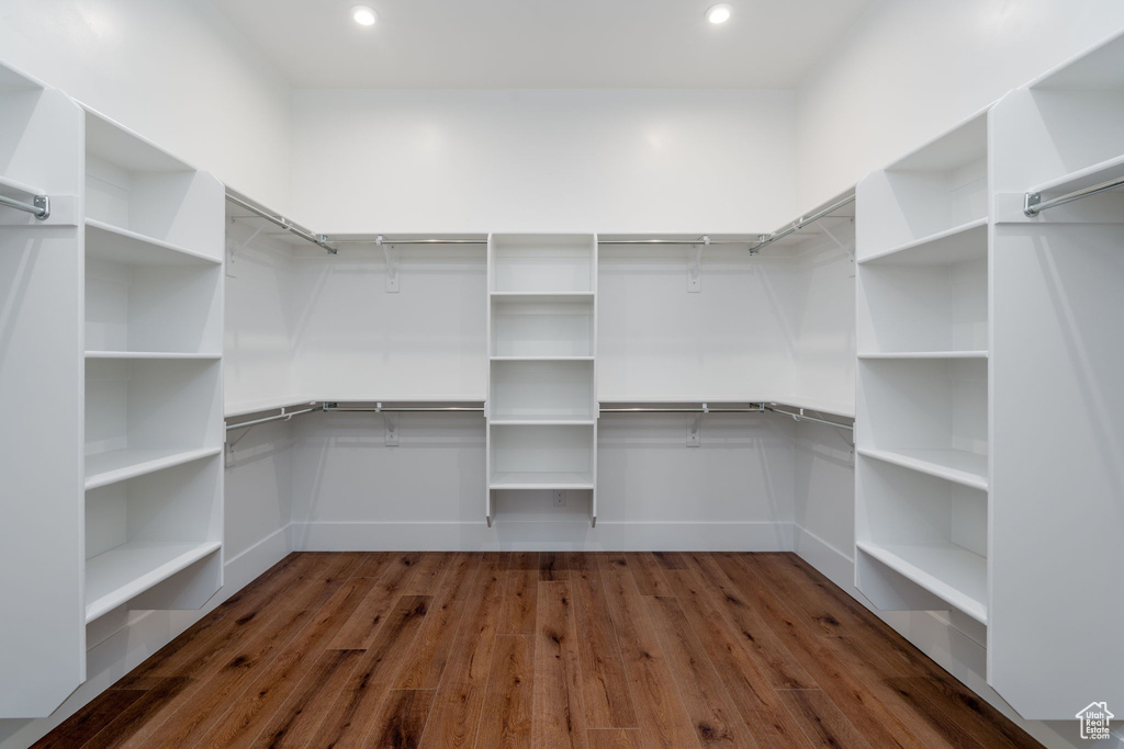 Spacious closet with dark wood-style floors