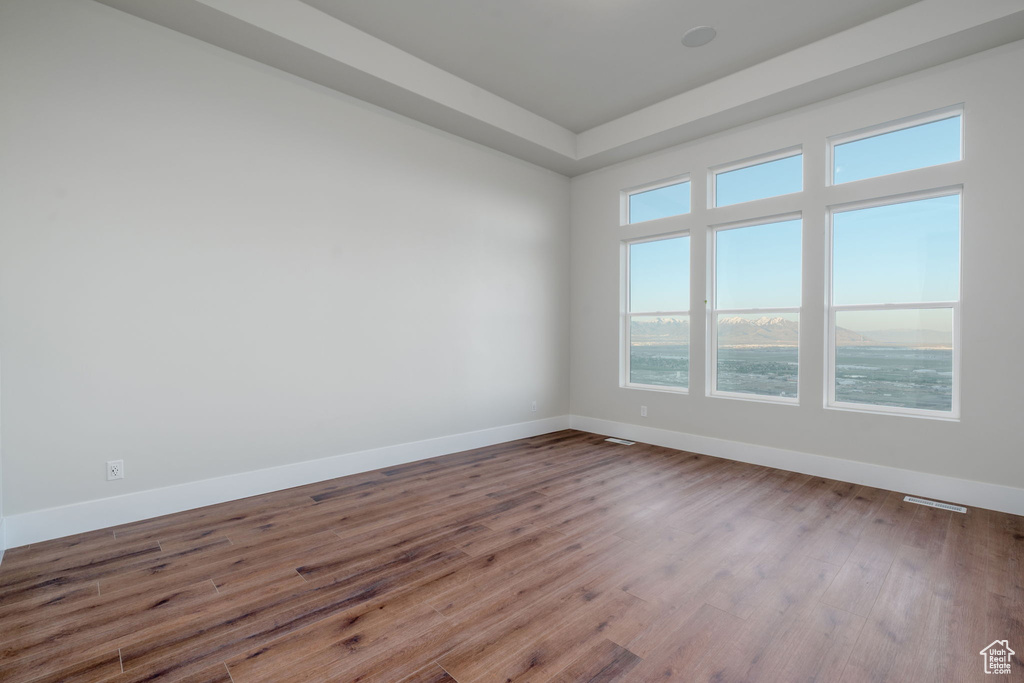 Spare room with wood finished floors and baseboards