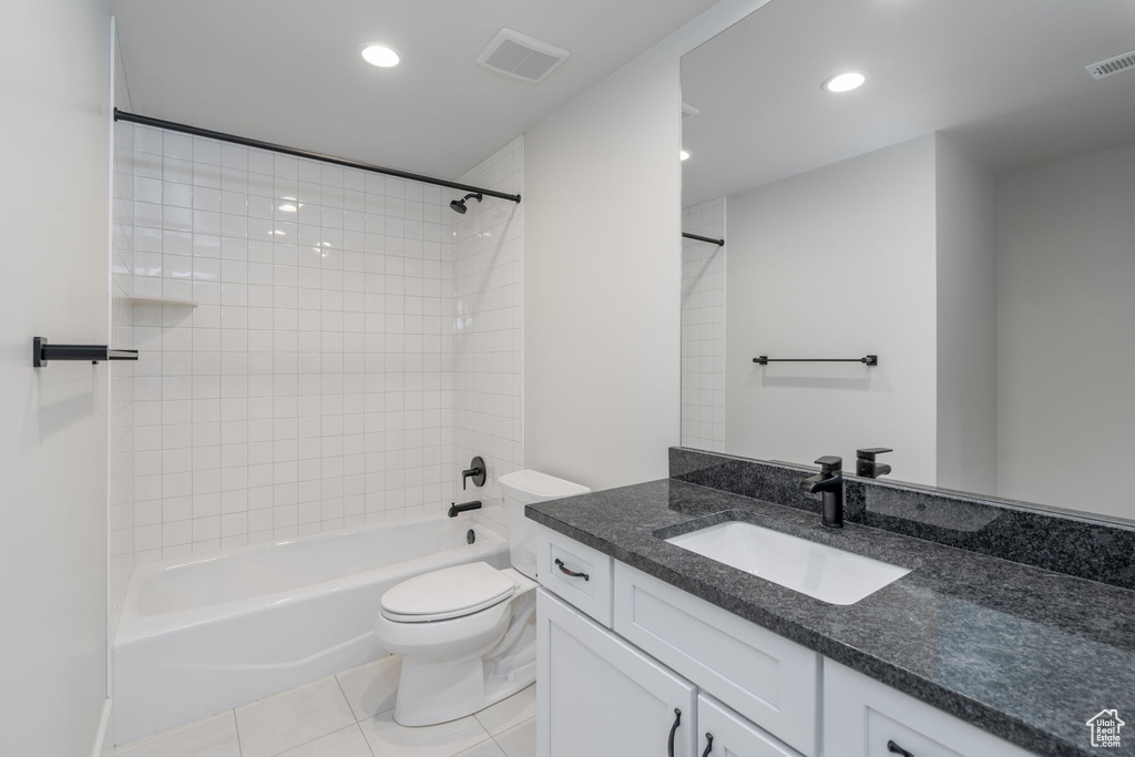 Bathroom featuring tile patterned flooring, toilet, recessed lighting, vanity, and bathing tub / shower combination
