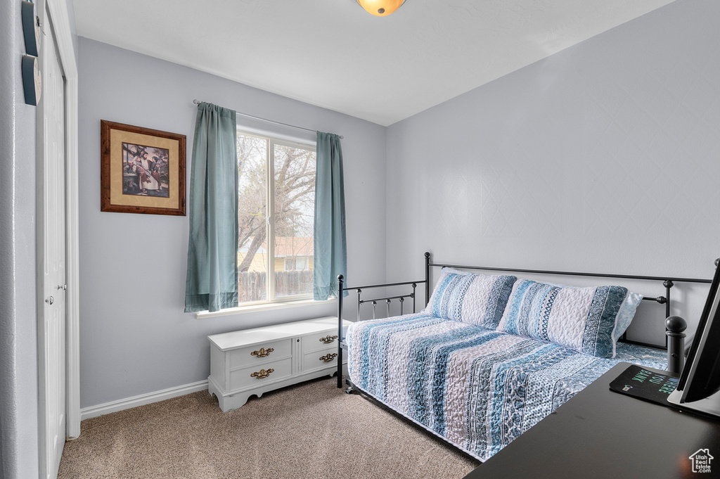 Carpeted bedroom with baseboards