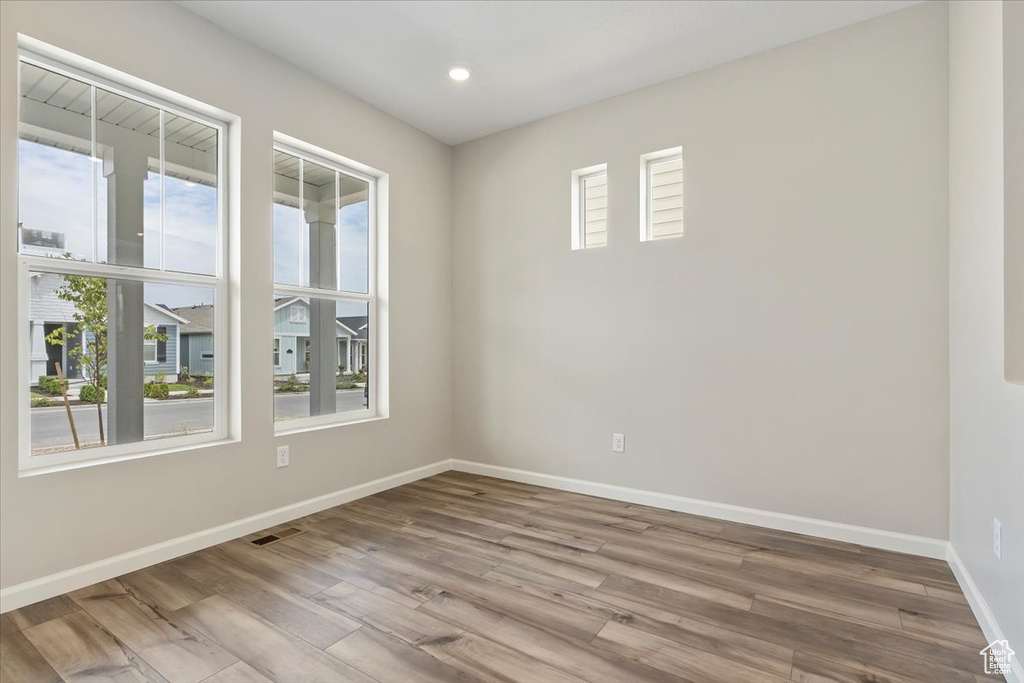 Spare room featuring recessed lighting, visible vents, baseboards, and wood finished floors