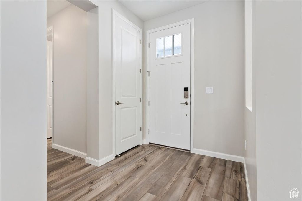 Foyer entrance featuring baseboards and light wood-style flooring
