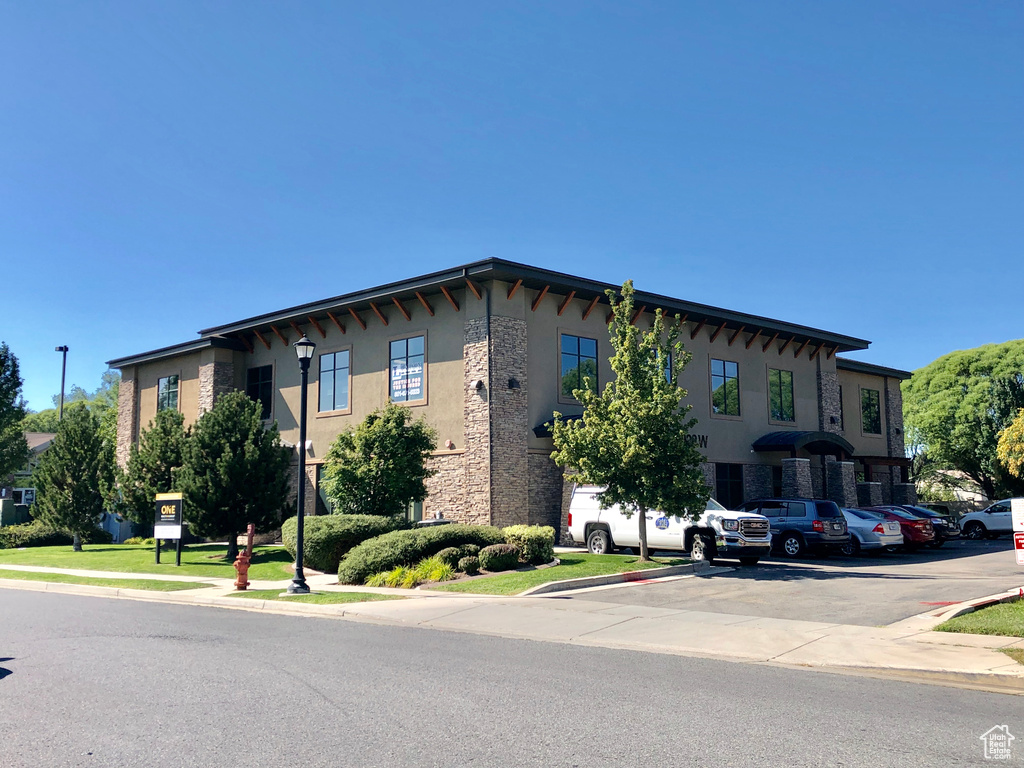 View of building exterior with uncovered parking