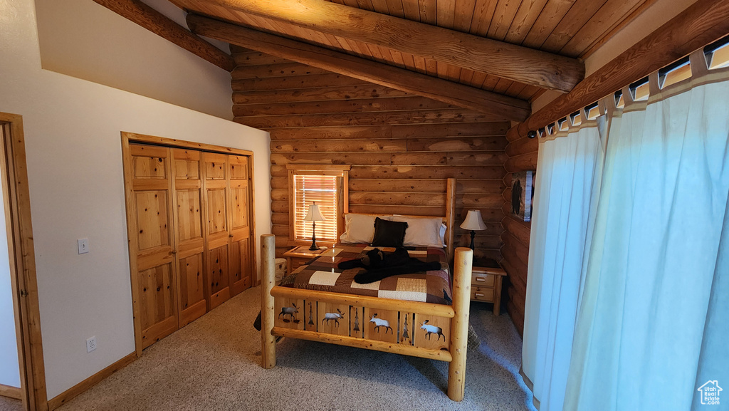 Bedroom featuring rustic walls, lofted ceiling with beams, baseboards, wood ceiling, and carpet floors