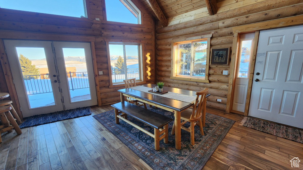 Dining space with hardwood / wood-style floors, wood ceiling, high vaulted ceiling, and french doors