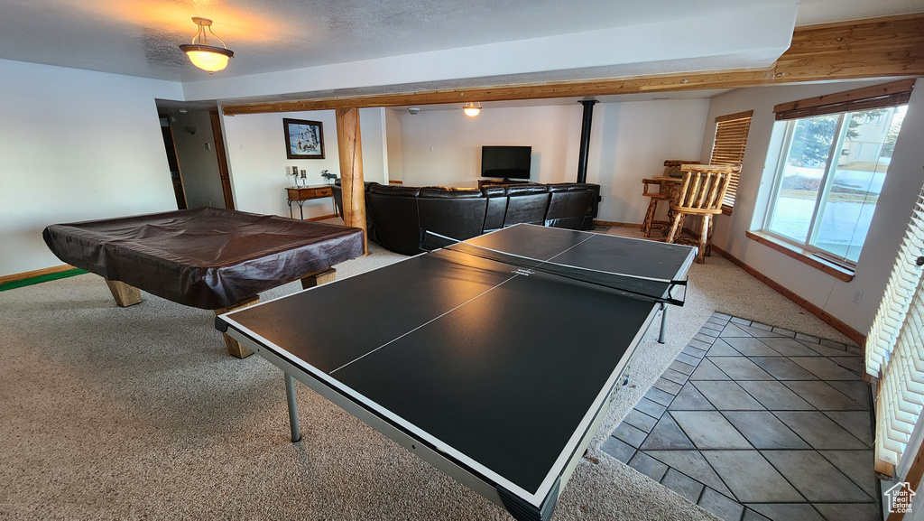 Rec room featuring tile patterned flooring, baseboards, a textured ceiling, carpet floors, and pool table
