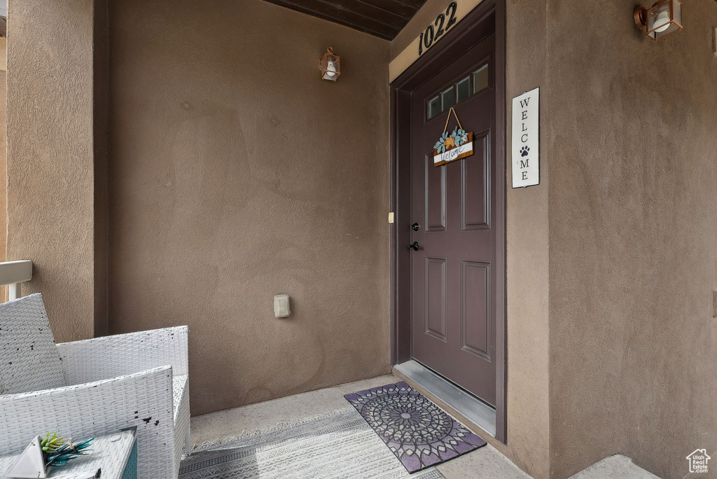 Doorway to property with stucco siding
