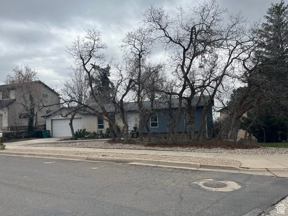 View of front of property featuring driveway and an attached garage