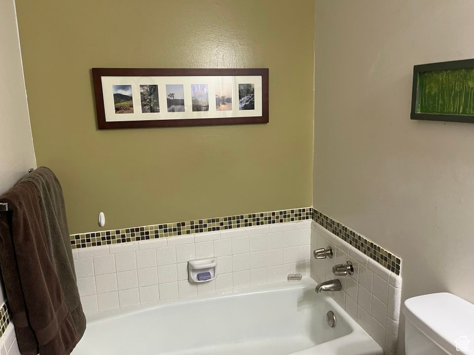 Bathroom featuring toilet and a garden tub