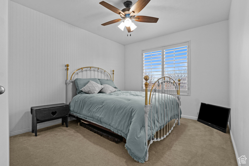 Bedroom with carpet flooring, a ceiling fan, and baseboards