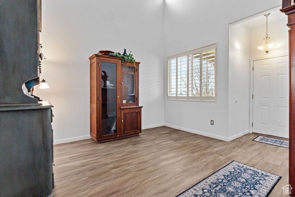 Entrance foyer featuring baseboards and light wood-style floors
