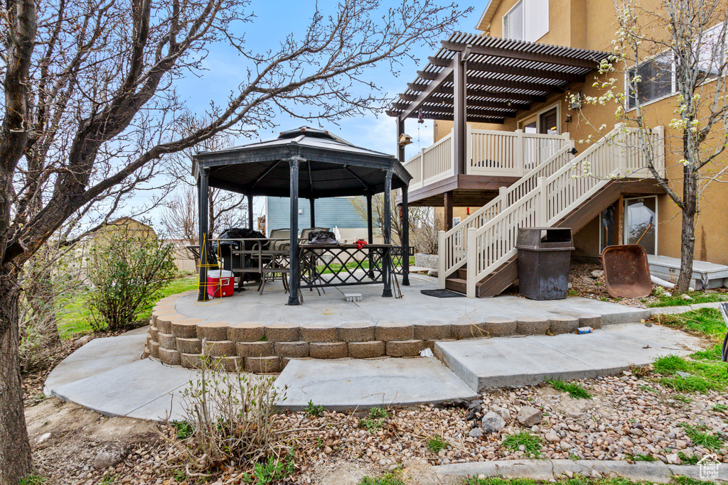 View of patio with a pergola, a gazebo, and stairs