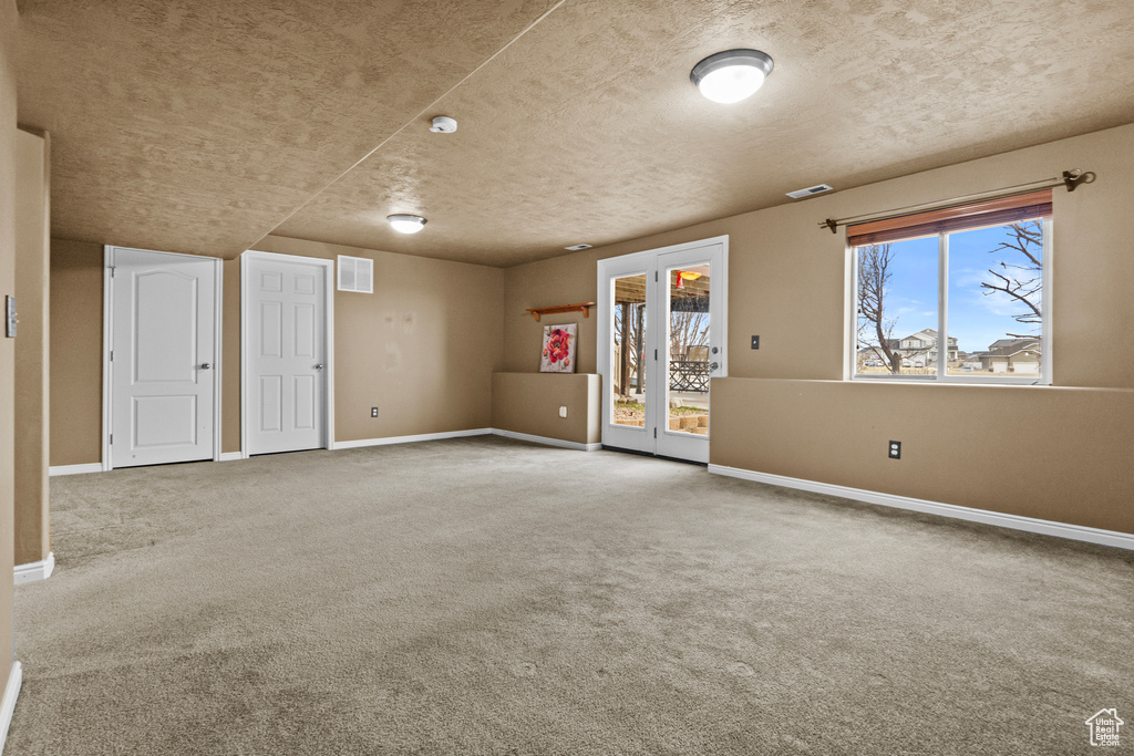 Spare room with carpet flooring, baseboards, and visible vents