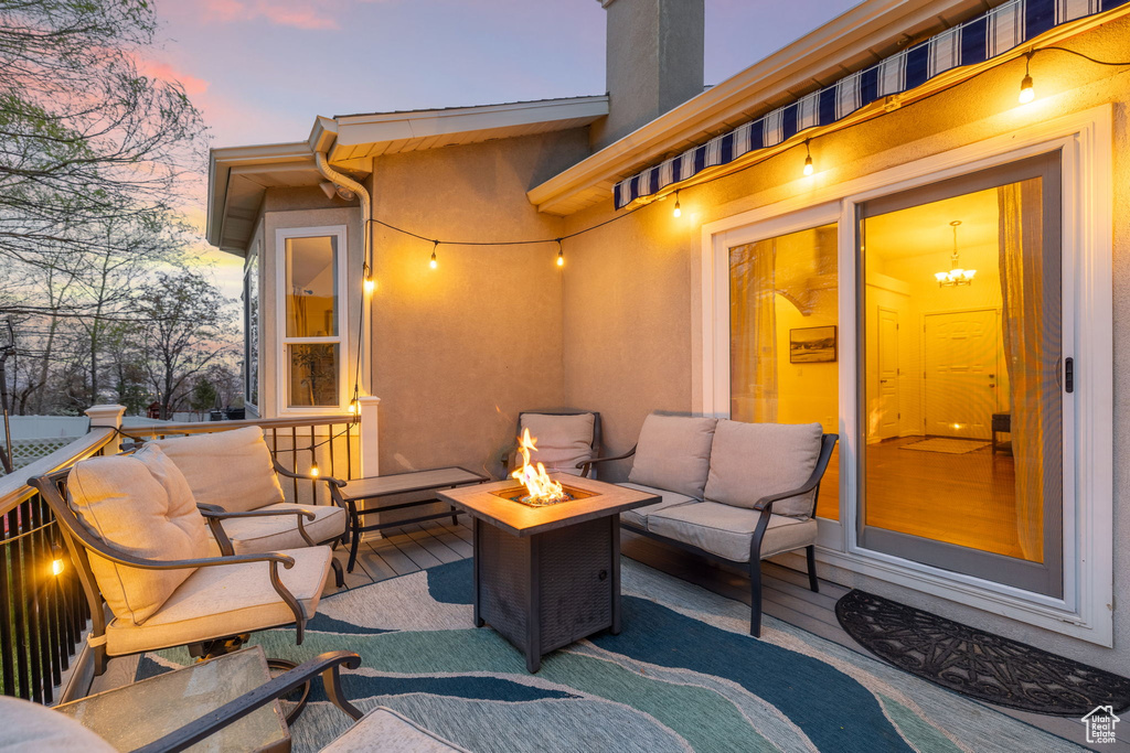 View of patio with an outdoor living space with a fire pit