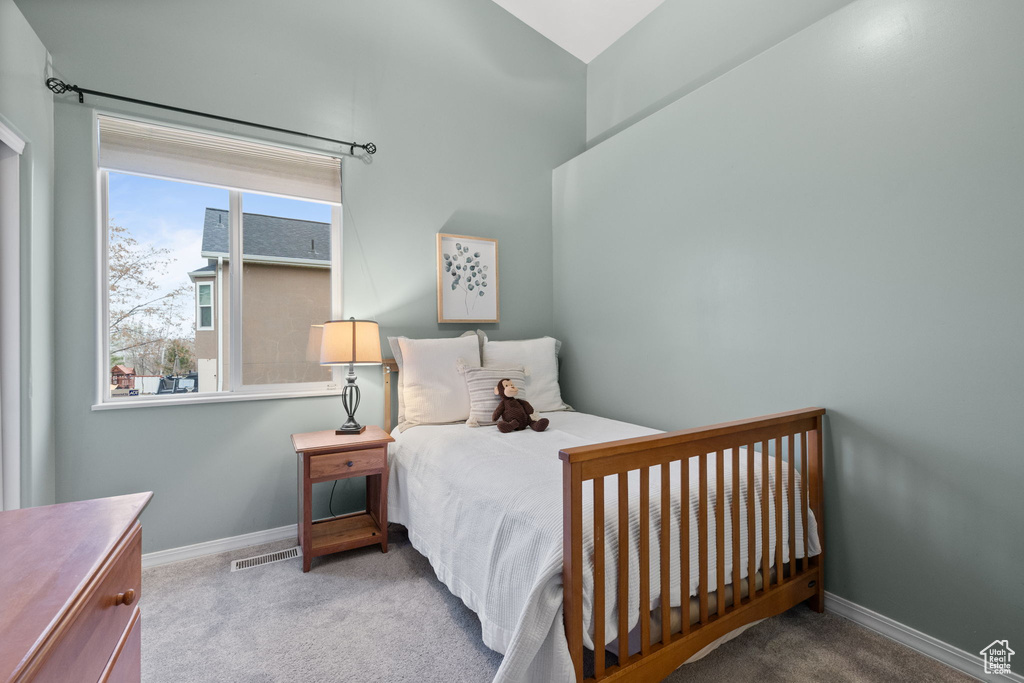 Bedroom with baseboards, carpet flooring, and visible vents