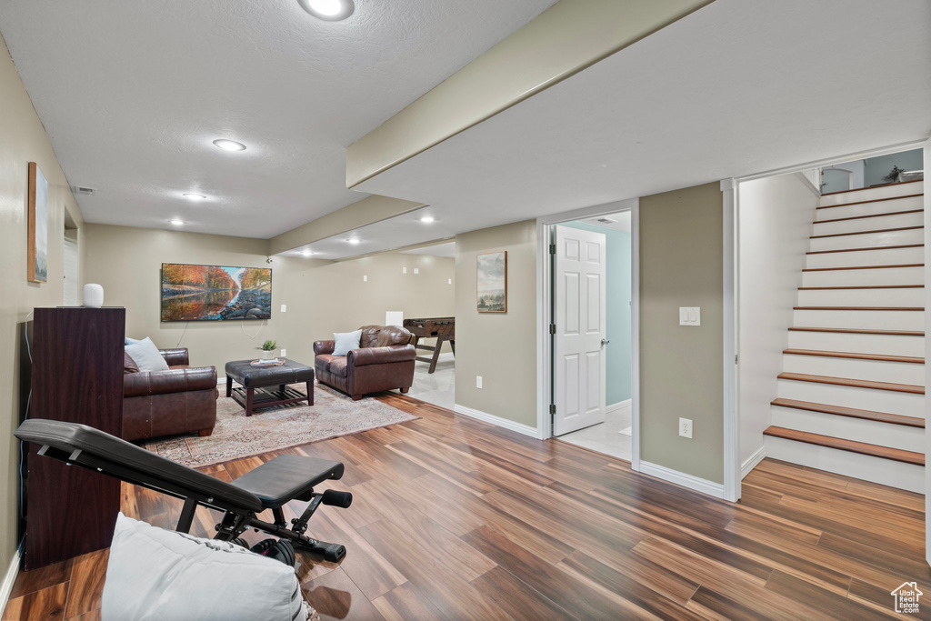 Workout area featuring recessed lighting, baseboards, and wood finished floors