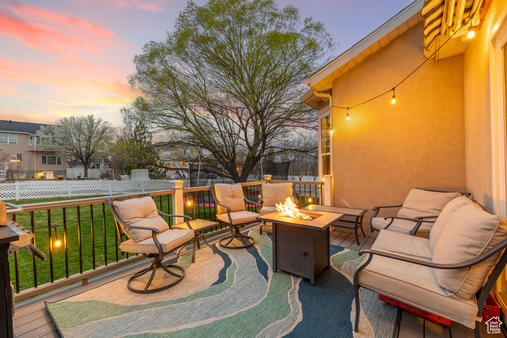 View of patio / terrace with fence and an outdoor living space with a fire pit