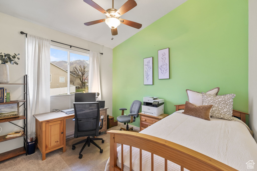 Bedroom with vaulted ceiling and a ceiling fan