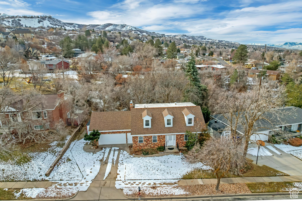 Snowy aerial view featuring a residential view and a mountain view