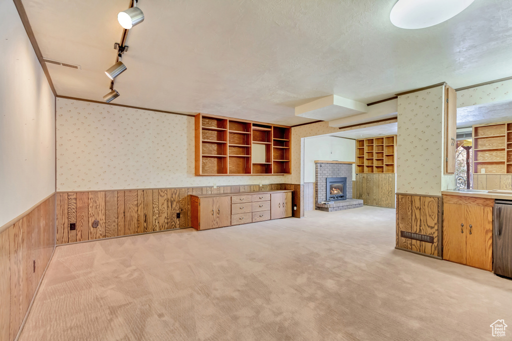 Kitchen with carpet floors, wallpapered walls, wooden walls, and wainscoting