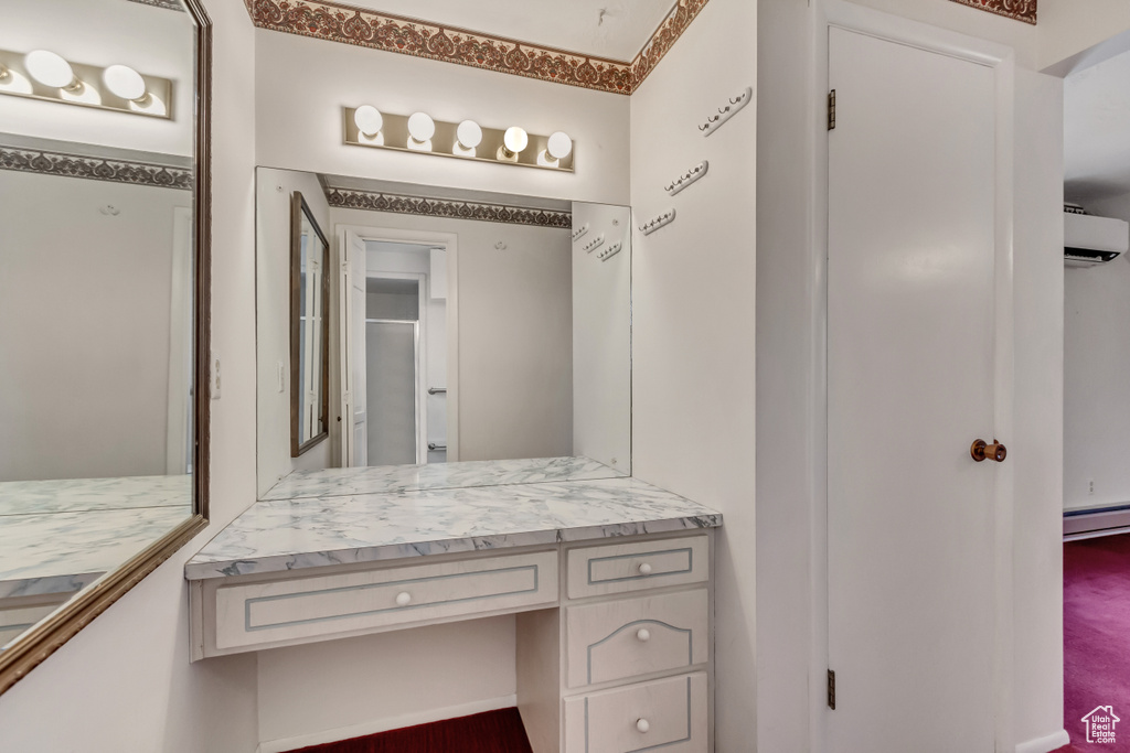 Bathroom with baseboard heating and vanity