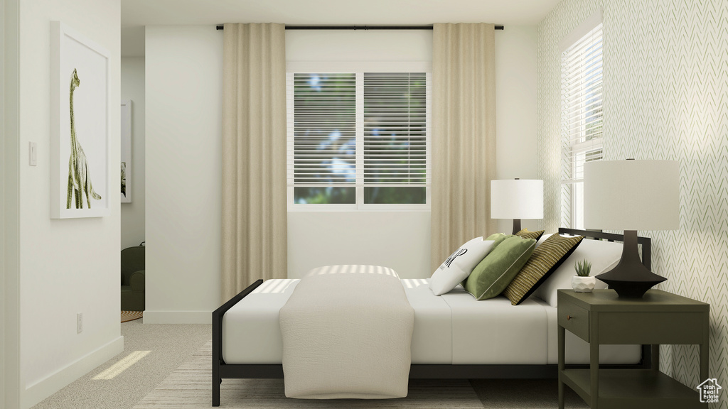Carpeted bedroom featuring baseboards and wallpapered walls
