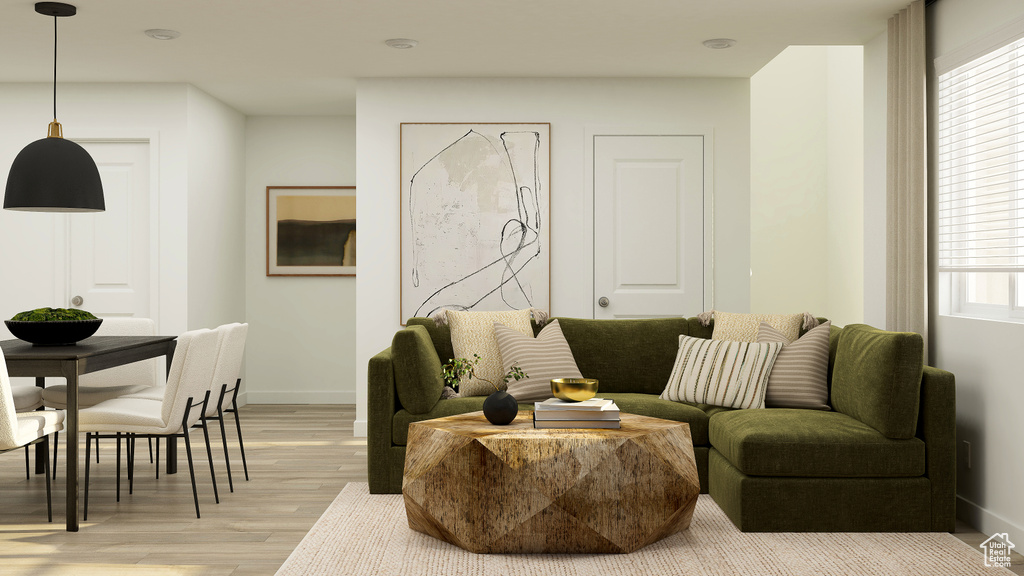 Living area with baseboards and light wood-type flooring