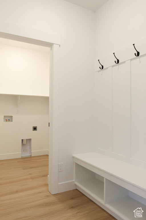 Mudroom featuring baseboards and light wood-style flooring