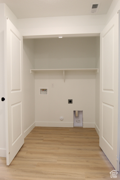 Laundry area featuring light wood-style flooring, washer hookup, laundry area, hookup for an electric dryer, and gas dryer hookup