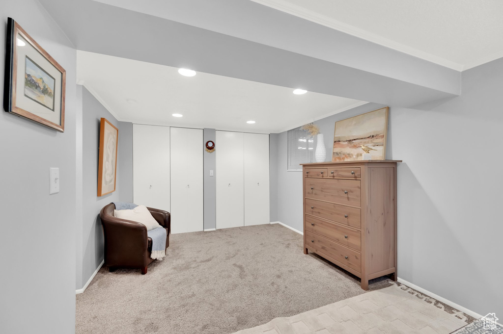 Sitting room with baseboards, crown molding, carpet floors, and recessed lighting