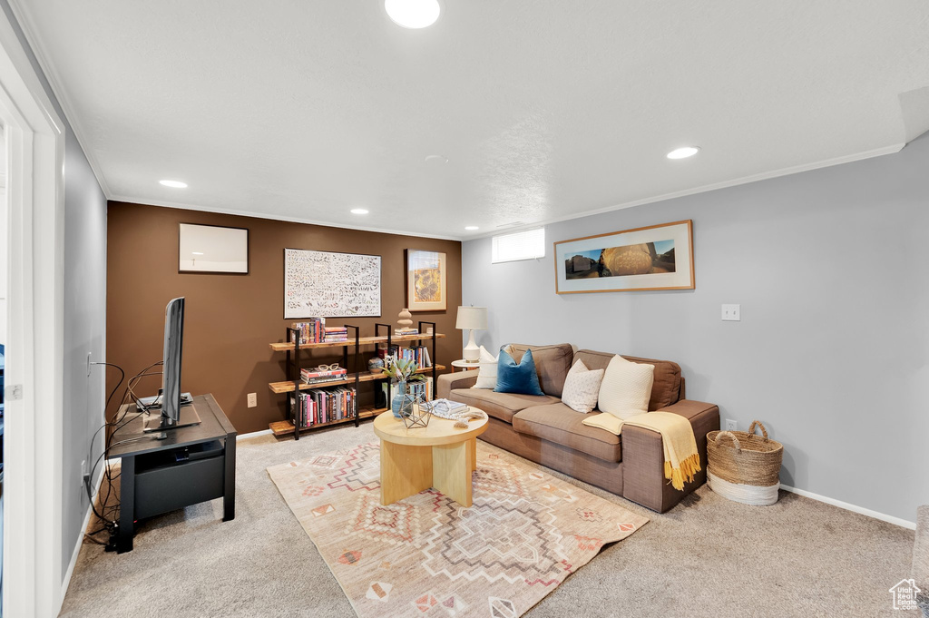 Living area with baseboards, recessed lighting, and light carpet
