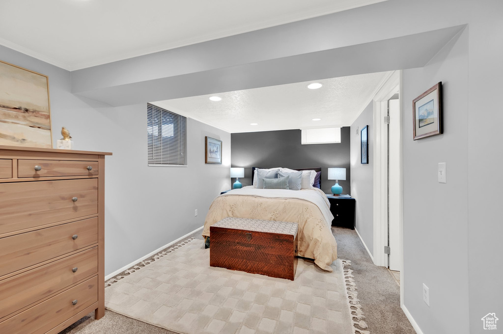 Bedroom featuring baseboards, recessed lighting, and light colored carpet