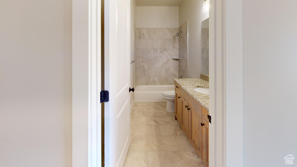 Full bath featuring toilet, vanity, and bathing tub / shower combination