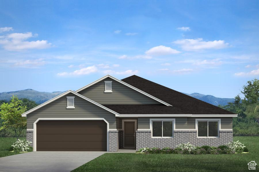 View of front of house featuring driveway, brick siding, a mountain view, and an attached garage